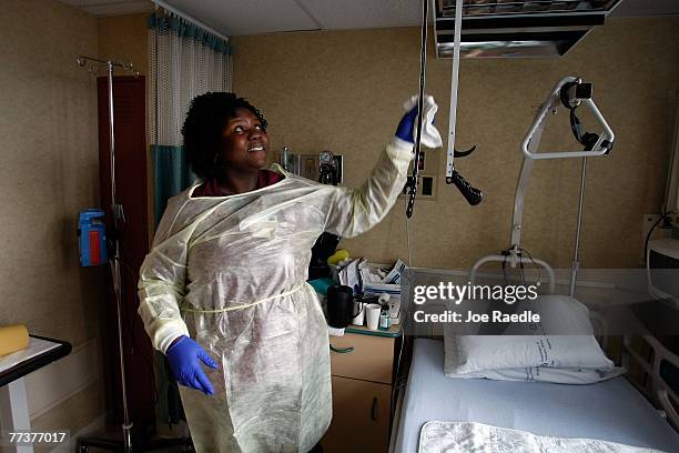 Miami VA Medical Center hospital house keeping aide, Shaquina Davis, wipes down a patients room with disinfectant October 17, 2007 in Miami, Florida....