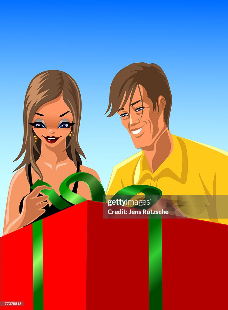 A man and woman opening a present