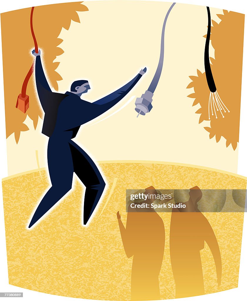 A man swinging from cord to cord