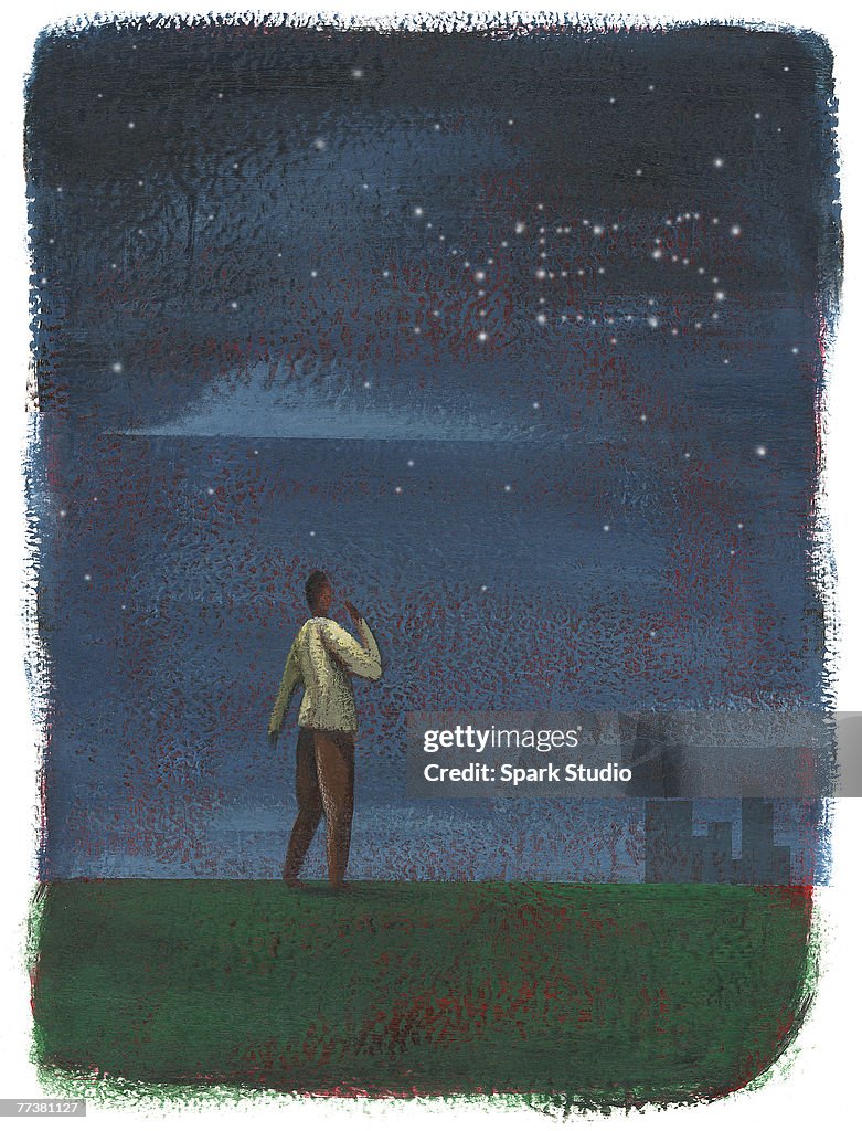 A man looking at the stars forming the word YES