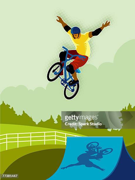 a man doing a bike trick - freihändiges fahrradfahren stock-grafiken, -clipart, -cartoons und -symbole
