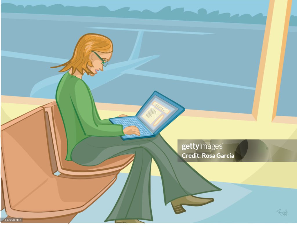 A businesswoman working while waiting for her flight at an airport