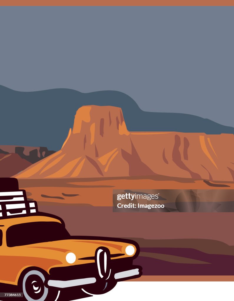 Car and luggage in front of a mesa in the US