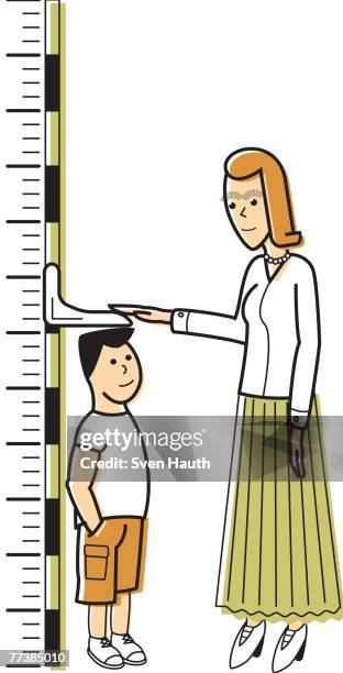 ilustraciones, imágenes clip art, dibujos animados e iconos de stock de a woman measuring a boy against a growth chart - height chart