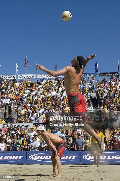 Matt Fuerbringer serves while partner Casey Jennings watches during the men's finals against Jake Gibb and Sean Rosenthal in the AVP San Francisco...