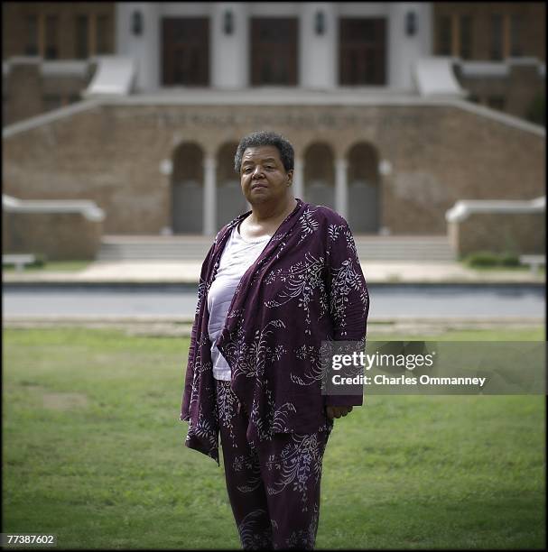 Elizabeth Eckford poses for a portrait on September 13, 2007 in front of the main entrance of Central High School in Little Rock, Arkansas. Threading...