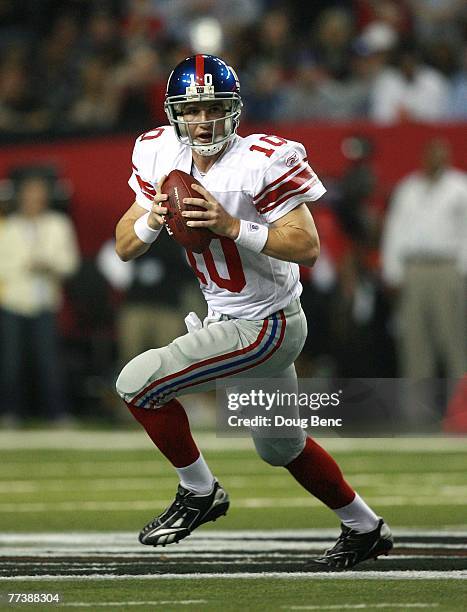 Quarterback Eli Manning of the New York Giants scrambles while taking on the Atlanta Falcons at Georgia Dome on October 15, 2007 in Atlanta, Georgia....