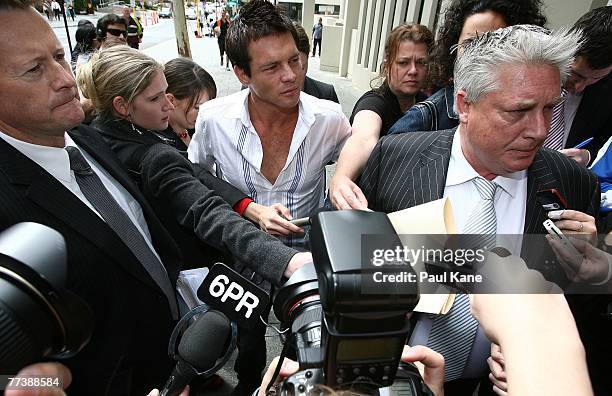 Former West Coast Eagles AFL player Ben Cousins looks on as lawyer Shane Brennan speaks with media attending the Perth Magistrates Court after facing...