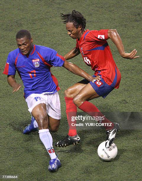 Costa Rican football player Junior Diaz vies for the ball with Alain Vuber from Haiti during their friendly match at the Ricardo Saprissa Stadium in...