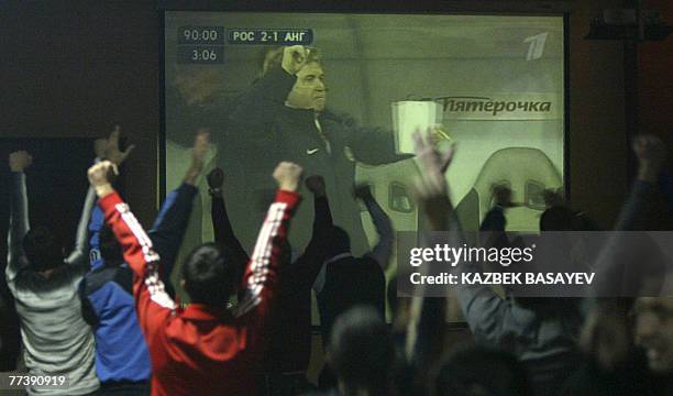 Picture made available 18 October 2007 shows Russian football fans in Vladikavkaz, the capital city of the Republic of North Ossetia-Alania, cheering...