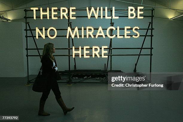 There Will Be No Miracles Here' by Turner Prize nominated artist Nathan Coley is viewed by visitors at Tate Liverpool on 18 October, 2007 in...