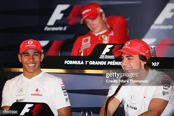 Mclaren Mercedes team mates Lewis Hamilton of Great Britain and Fernando Alonso of Spain appear at the drivers press conference during previews prior...