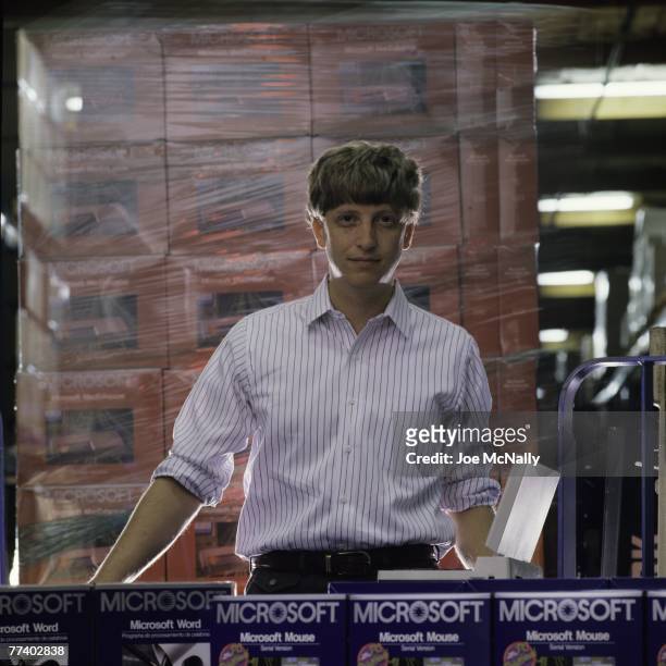 Microsoft owner and founder Bill Gates poses in front of boxes of Microsoft products in 1986 at the packaging facility in the new 40-acre corpororate...