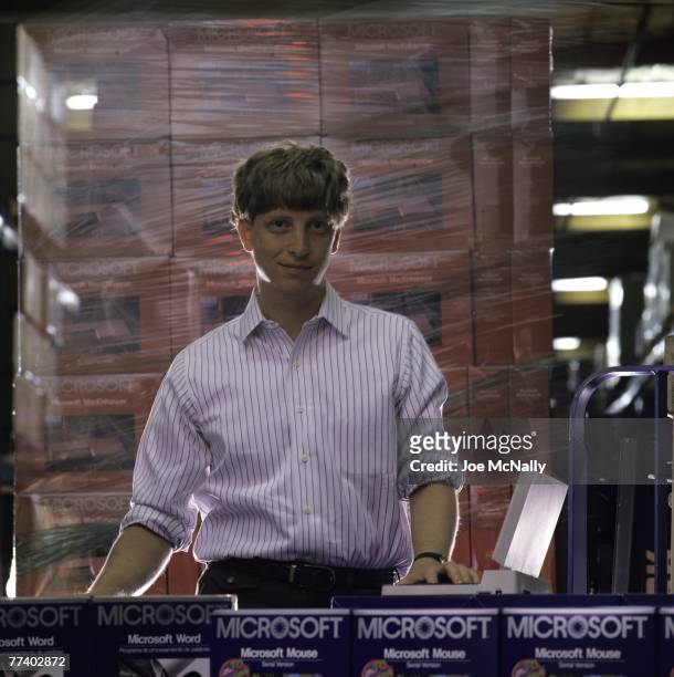 Microsoft owner and founder Bill Gates poses in front of boxes of Microsoft products in 1986 at the packaging facility in the new 40-acre corpororate...
