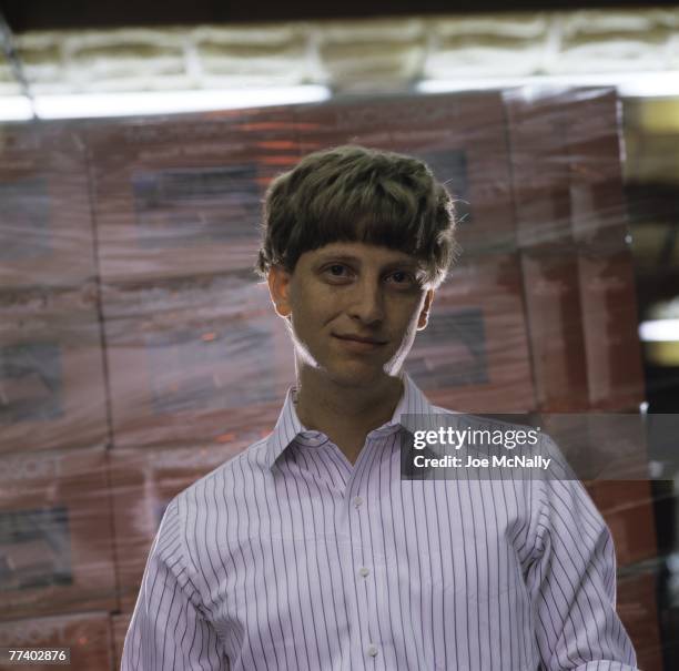 Microsoft owner and founder Bill Gates poses in front of boxes of Microsoft products in 1986 at the packaging facility in the new 40-acre corpororate...