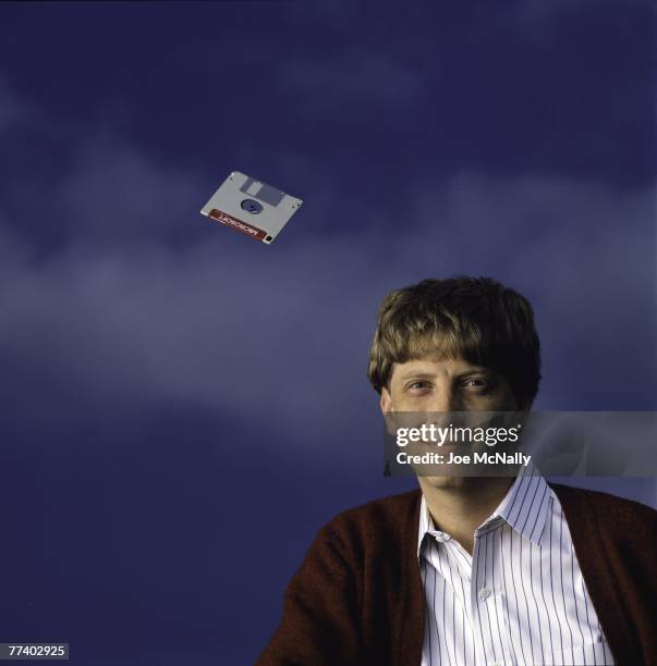 Microsoft owner and founder Bill Gates poses with a hovering floppy disk in 1986 at the new 40-acre corpororate campus in Redmond, Washington. In...