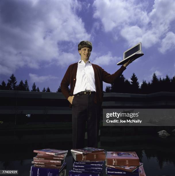 Microsoft owner and founder Bill Gates poses outdoors with Microsoft's first laptop in 1986 at the new 40-acre corpororate campus in Redmond,...