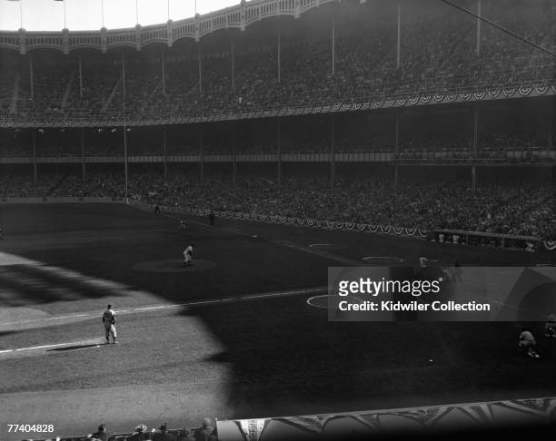 Pitcher Don Larsen, of the New York Yankees, throws a strike past pinch hitter Dale Mitchell of the Brooklyn Dodgers with two outs in the ninth...