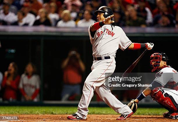 Manny Ramirez of the Boston Red Sox hits a single in the third inning against the Cleveland Indians during Game Five of the American League...