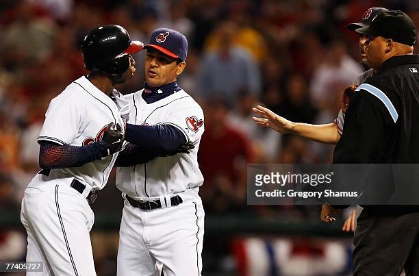 First base coach Luis Rivera holds back Kenny Lofton of the Cleveland Indians as he has words with Josh Beckett of the Boston Red Sox in the fifth...