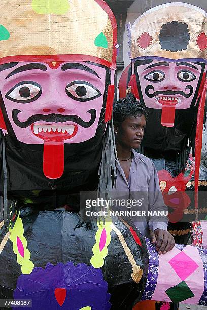 Indian boy Sanpath sells effigies of the Hindu demon King Ravana on the road side in Amritsar, 19 October 2007, for the upcoming Hindu festival of...