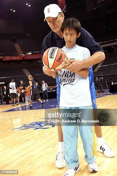 Legend Rick Barry works with a participant of a NBA Cares Special Olympics Basketball Clinic as part of the 2007 NBA China Games on October 19, 2007...