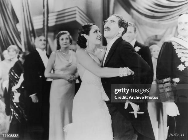 American actor Groucho Marx succombs to the charms of Mexican actress Raquel Torres in the Paramount Pictures production 'Duck Soup', 1933.