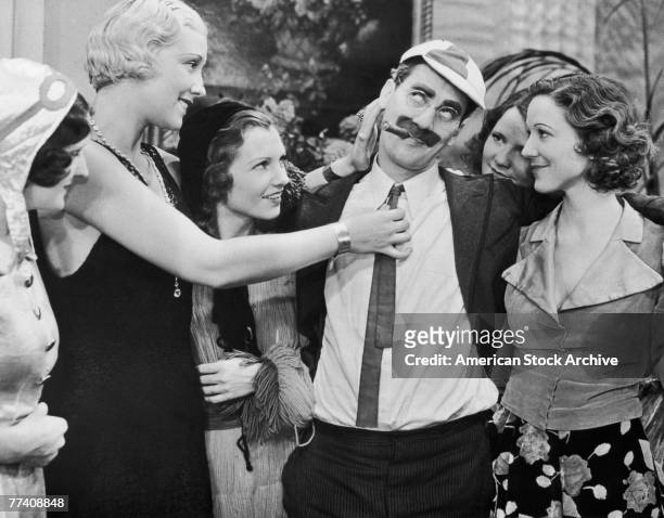 Groucho Marx , as Doctor Hugo Z. Hackenbush, basks in the attentions of a group of young women in a scene from the Marx Brothers comedy 'A Day at the...
