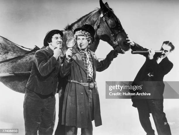 Chico Marx , Harpo Marx and Groucho Marx in a promotional still for the comedy 'A Day at the Races', directed by Sam Wood, 1937.