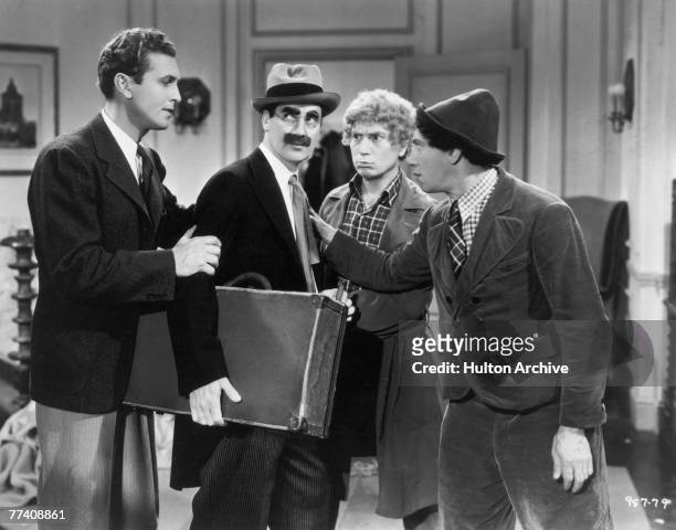 Allan Jones , Groucho Marx , Harpo Marx and Chico Marx in a scene from the Marx Brothers comedy 'A Day at the Races', directed by Sam Wood, 1937.
