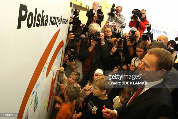 The leader of the main Polish opposition party the Civic Platform , Donald Tusk, meets children on the last day of the election campaign in Warsaw 19...