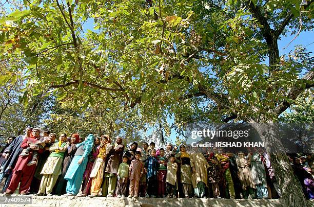 Kashmiri villagers observe proceedings during the funeral procession of suspected Hezb-ul-Mujahedeen militant Irhad Ahmed Dar in Chicloora,some 28...