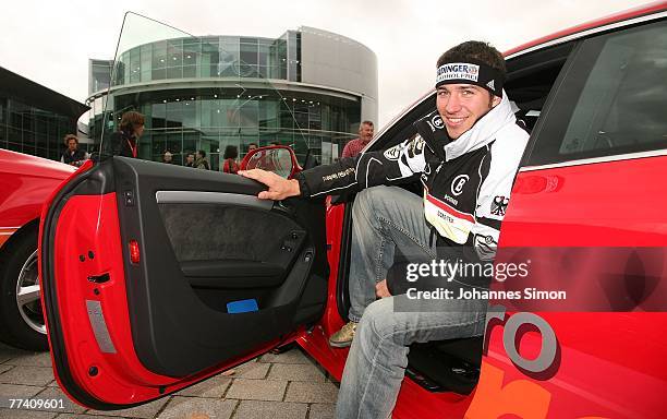 Felix Neureuther, alpine skier of the DSV German Ski Association, poses in an Audi Quattro car after a press conference at Audi Forum on October 19,...