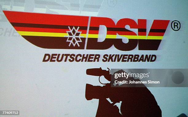 Camera man is shadowed against a giant screen with the logo of the DSV German Ski Association during a press conference at Audi Forum on October 19,...