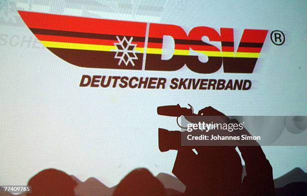 Camera man is shadowed against a giant screen with the logo of the DSV German Ski Association during a press conference at Audi Forum on October 19,...