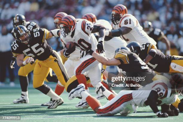 Garrison Hearst, Running Back for the Cincinnati Bengals carries the football through the Steelers defense during the American Football Conference...