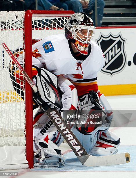Miikka Kiprusoff of the Calgary Flames watches the play along the boards against the Nashville Predators at the Sommett Center on October 13, 2007 in...