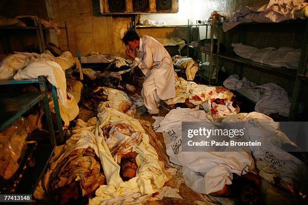 Family members come to identify the dead at the Edhi Morgue October 19, 2007 in Karachi, Pakistan. A suicide bombing killed at least 136 people in an...