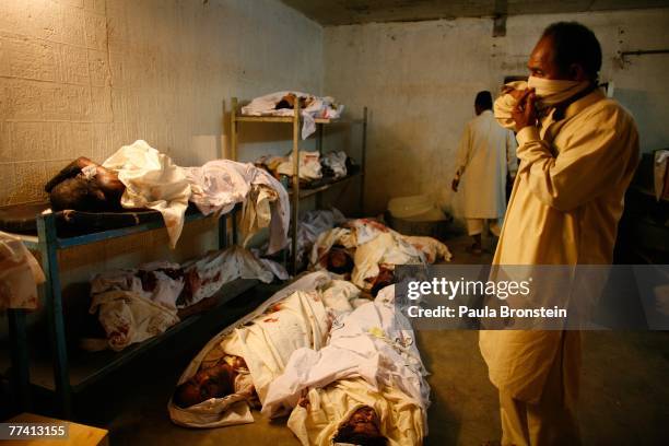 Family members come to identify the dead at the Edhi Morgue October 19, 2007 in Karachi, Pakistan. A suicide bombing killed at least 136 people in an...