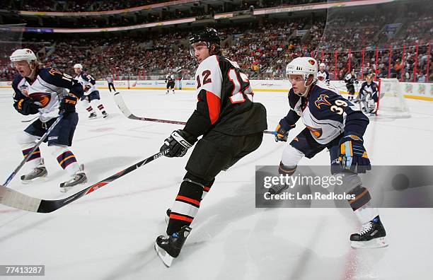 Simon Gagne of the Philadelphia Flyers skates between Tobias Enstrom and Bryan Little of the Atlanta Thrashers on October 16, 2007 at the Wachovia...