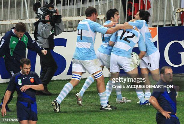 Argentina's centre Felipe Contepomi is congratulated by teammates Argentina's lock Rimas Alvarez Kairelis, winger Horacio Agulla and scrum-half and...