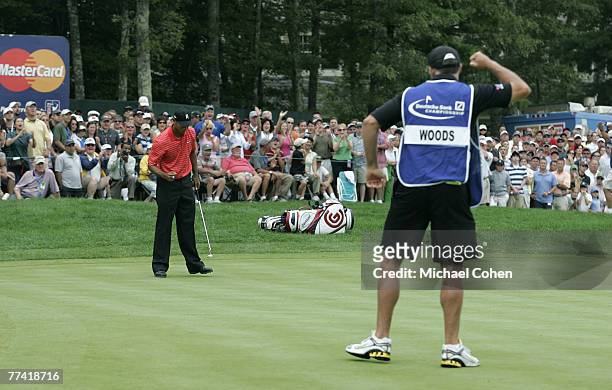 Tiger Woods , and his caddie Steve Williams react to a par save on the ninth hole during the fourth round of the 2006 Deutsche Bank Championship held...