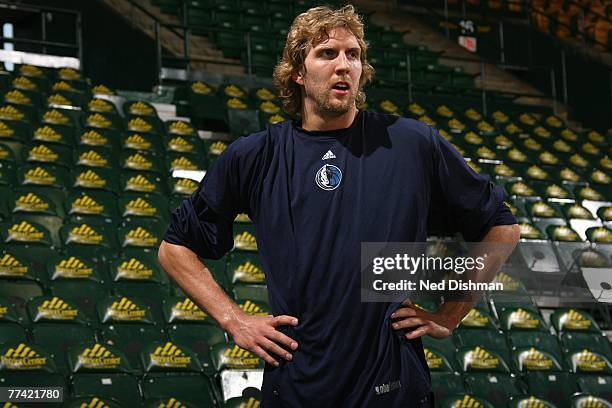 Dirk Nowitzki of the Dallas Mavericks smiles as he looks on during warm-ups prior to a preseason game against the Washington Wizards at the Patriot...