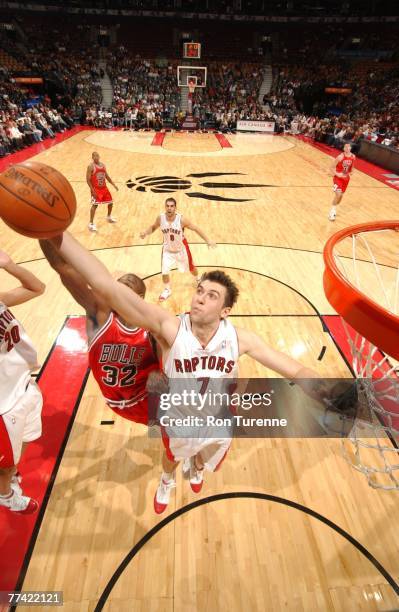 Andrea Bargnani of the Toronto Raptors grabs a loose ball in front of Joe Smith of the Chicago Bulls in a preseason game at the Air Canada Centre...
