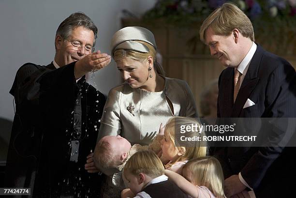Dutch Crown Prince Willem-Alexander and Princess Maxima hold their youngest daughter Princess Ariane during her baptism ceremony by Reverend Deodaat...