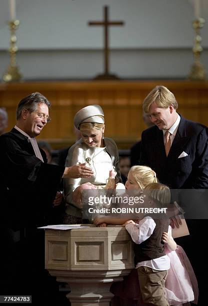 Dutch Crown Prince Willem-Alexander and Princess Maxima hold their youngest daughter Princess Ariane during her baptism ceremony by Reverend Deodaat...