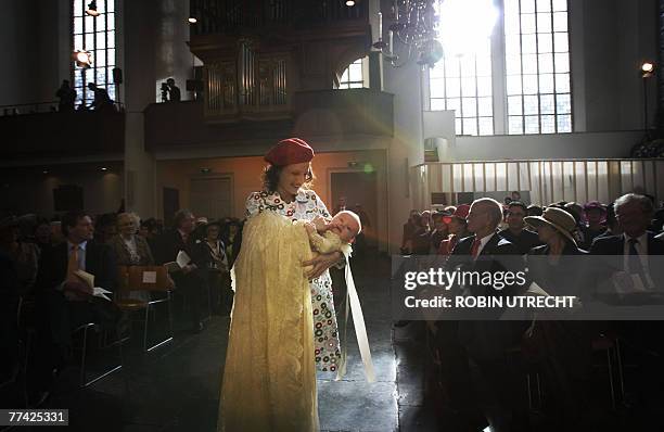 Dutch Princess Ariane is carried by the sister of Princess Maxima to her baptism ceremony in the Kloosterkerk in The Hague 20 October 2007. AFP PHOTO...