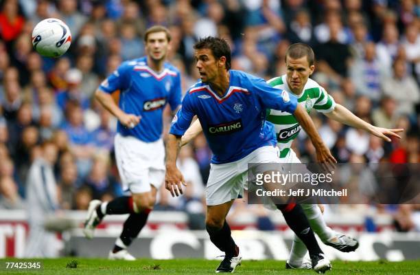 Nacho Novo of Rangers goes past Gary Caldwell of Celtic during the Scottish Premier League match between Rangers and Celtic at Ibrox Stadium on...