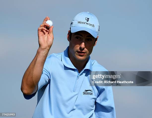 Ross Fisher of England reacts to a birdie putt on the 7th green during the third round of the Portugal Masters at Oceanico Victoria Clube de Golfe on...