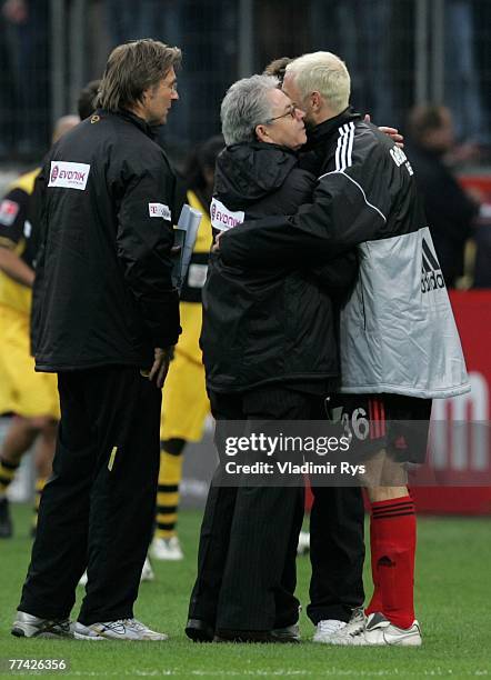 Sergej Barbarez of Leverkusen hugs press officer Josef Schneck of Dortmund after the end of the Bundesliga match between Bayer Leverkusen and...